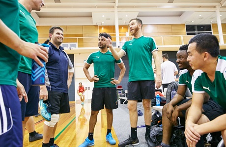 Men's futsal team talking tactics