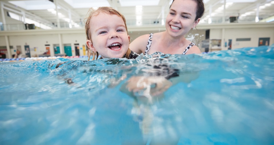 Happy mum and son playing together in HBF Arena's aquatic centre