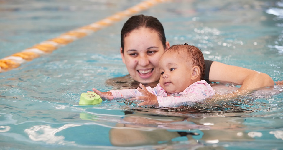 Mother and daughter enjoying a parent baby swim class