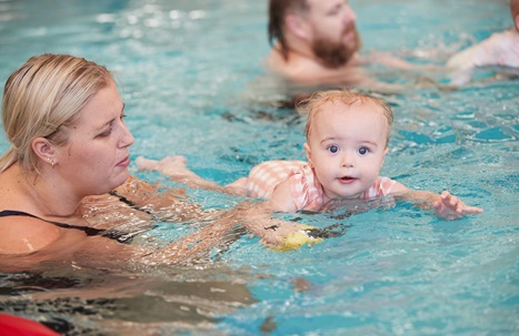 Mother and daughter in a parent baby swim class