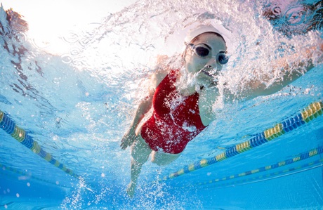 Underwater view of fit woman swimming laps