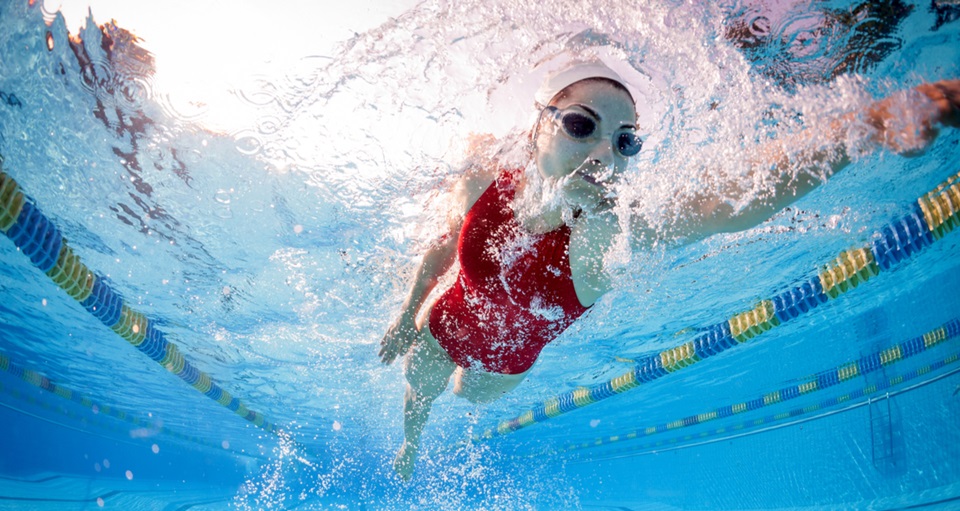 Underwater view of fit woman swimming laps